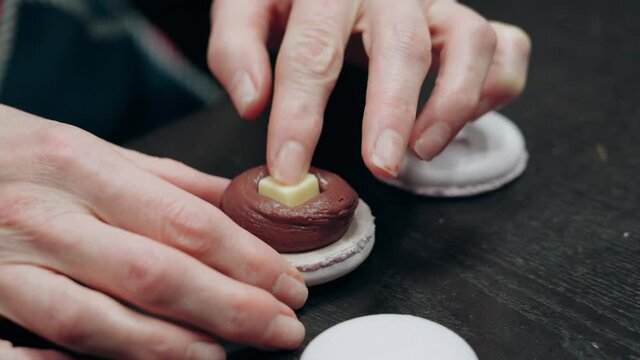 woman making macarons with her hands 4K