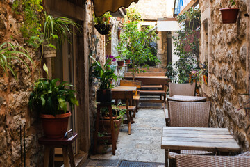 Cozy street cafe in a narrow street in the old town. Empty cafe. Budva, Montenegro.