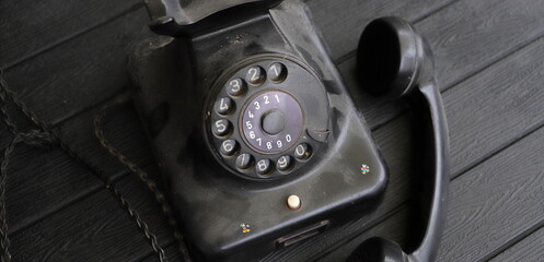 an old dusty black rotary phone