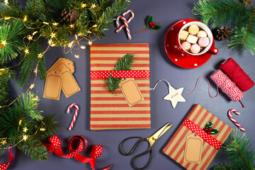 Christmas gift wrapping creative concept layout flatlay. Traditional kraft paper wrapped gifts with twine on dark blue background.
