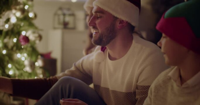Happy family heating fireplace on Christmas eve
