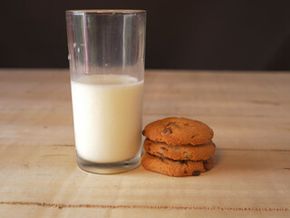 Glass of fresh milk and baked cookies medium shot 