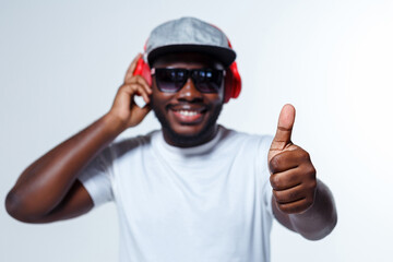 A singer is showing thumb up while listening to music.