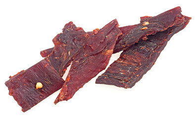 Beef jerky pieces isolated on a white background. Portion of sliced and dried meat.