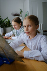 Two girls, sisters study at home, distance learning