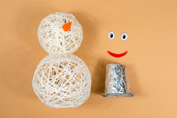 Snowman made of threads. A set of items for making a handmade snowman. Threads, inflated balls,...