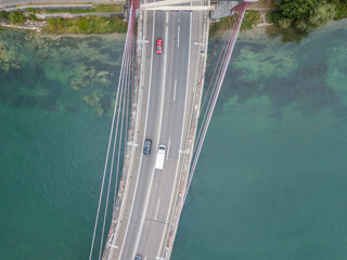 Aerial view of road bridge over river in Switzerland with car traffic