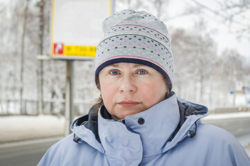 Woman in blue ski tracksuit and sports cap