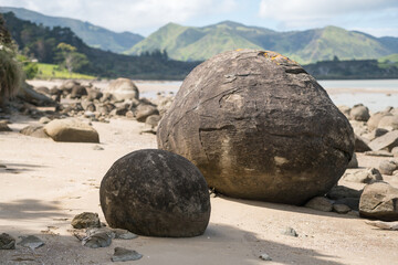 Fototapeta na wymiar Koutu Boulders beach with perfect ball shape in New Zealand