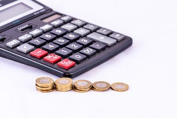 Coins and calculator on an isolated white background. Money.