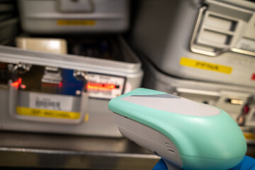 Instrument containers are detected in an operating room with a handheld scanner