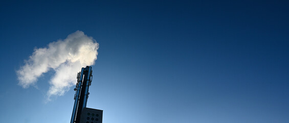 Smoke from chimney industry with blue sky.