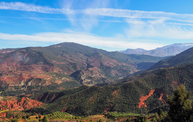 Typical Morocco landscape in area near Foret Toufliht park - red mountains with low green trees and bushes