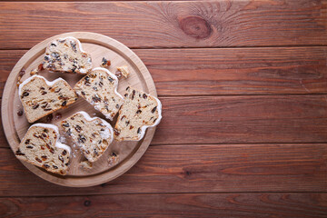 Dresdner Stollen is a Traditional German Cake with raisins on wooden background with place for text. Fruit cake for the Holiday.
