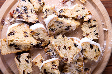 Dresdner Stollen is a Traditional German Cake with raisins on wooden background Fruit cake for the Holiday.