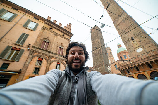 Happy man tourist take selfie photo in Bologna, Italy. vintage colors filter post production