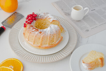 Orange cake with decorated red berries, orange slices. Morning homemade breakfast. Daylight. White background.on a marble background