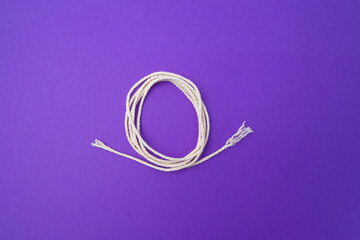 White rope on a purple background.