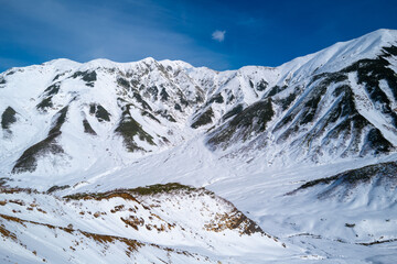 富山県立山町にある立山の冬の雪景色のある風景 Landscape with snowy winter scenery of Tateyama in Tateyama Town, Toyama Prefecture, Japan.