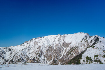 富山県立山町にある立山の冬の雪景色のある風景 Landscape with snowy winter scenery of Tateyama in Tateyama Town, Toyama Prefecture, Japan.