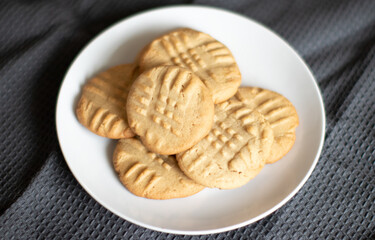 Peanut Butter Cookies on a white plate with gray tablecloth