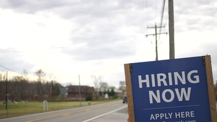 Help Wanted sign hanging by side of a rural West Virginia road in autumn.