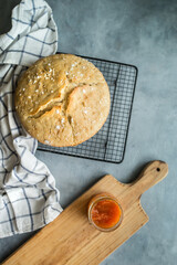 rustic handmade bread on a grey background. bread slices, marmalade and a wood board