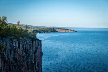 Behangcirkel Beautiful landscape along the north shore of Lake Superior in Minnesota, from Palisade Head, a natural sheer cliff at the edge of the blue water. Evening image at the shore of Gitchi-Gami. © scandamerican