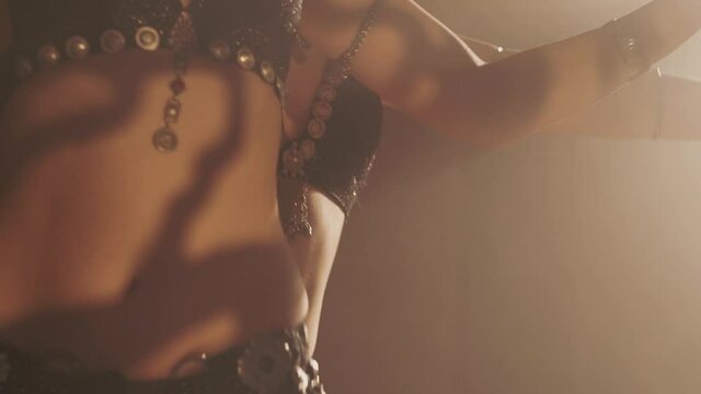 Sensual women dancing in light and shadow. Focus in the depth of the frame