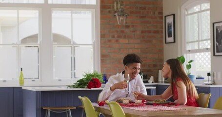 Happy biracial couple having valentine's day celebration meal at home - Powered by Adobe