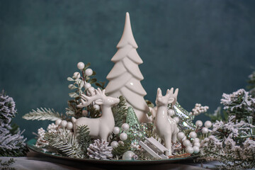 Living room with Christmas decorations with fir trees, globes and angels 