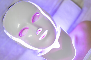 LED mask regenerative treatment applied to a young woman