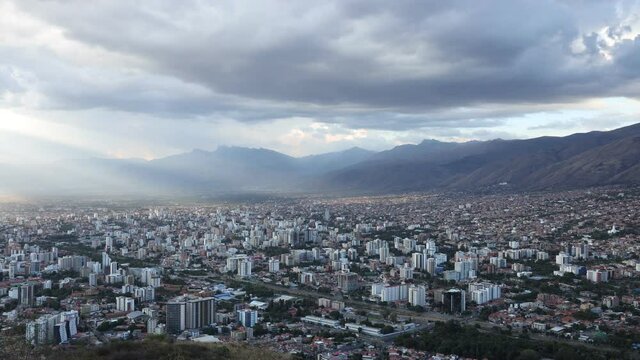 Cinematic cityscape timelapse video of Cochabamba Bolivia South America  on a cloudy afternoon during golden hour shortly before sunset