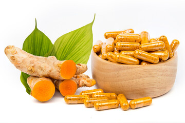 Fresh turmeric and turmeric powder in capsules, Thai herbs. isolated on white background.