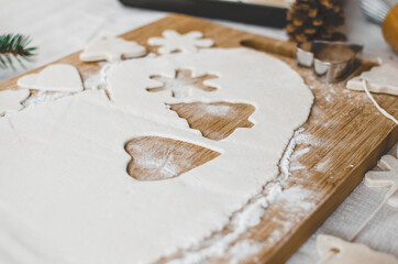 White, salt dough, homemade Christmas tree ornaments in the shape of trees, hearts and snowflakes.