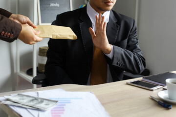 Business man refusing money to take the bribe, the concept of corruption and anti bribery
