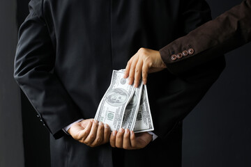 Corruption and Bribery,Businessman  receive money from another Business man from behind to deal...