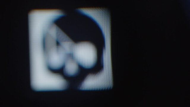 Skull Icon on Monitor Screen Pixelated with Mouse Closeup
