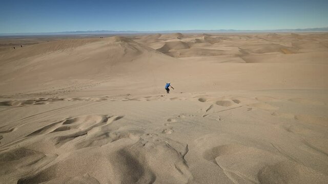 Sandboarder at Great Sand Dunes National Park, Colorado, USA