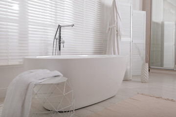 Minimal bathroom interior with modern white tub