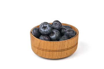 A small wooden bowl with blueberries isolated on a white background.