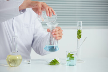 Plants extract in petri dish and a white background in laboratory , green leaf  in a test tube and doctor for cosmetic advertising , photography science concept
