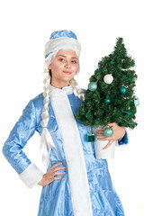 Beautiful girl dressed as a Snow Maiden with a small Christmas tree in her hands on a white background