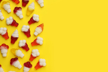 Tasty jelly candies in shape of ice cream on yellow background, flat lay. Space for text