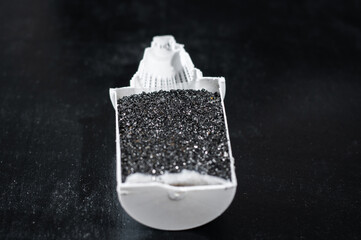 Filler made of activated carbon and ion-exchange resin for loading into a water purification filter, close-up