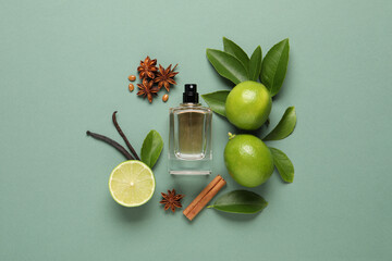 Flat lay composition with bottle of perfume and fresh citrus fruits on pale green background - obrazy, fototapety, plakaty