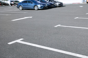 Car parking lot with white marking outdoors
