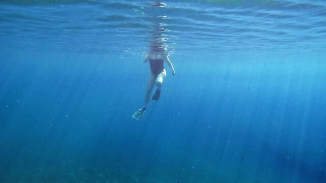 Caucasian Girl Is Snorkeling Under Blue Sea Of Kefalonia Cove In Ionian Sea, Greece. Underwater