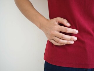 Asian woman suffers lateral abdominal pain due to salpingitis. health concept. closeup photo, blurred.
