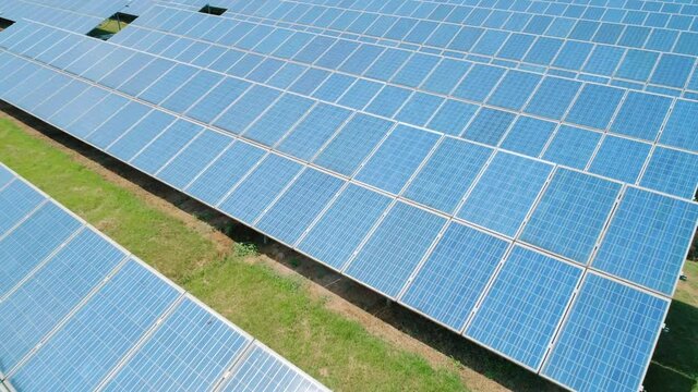 Aerial view of Solar Panels Farm solar cell. Renewable green alternative energy concept. Camera moves forward
